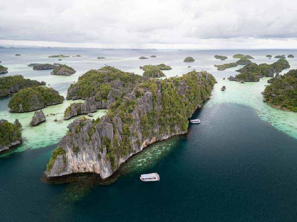 The View From Above If Boat And Limestone Mountains