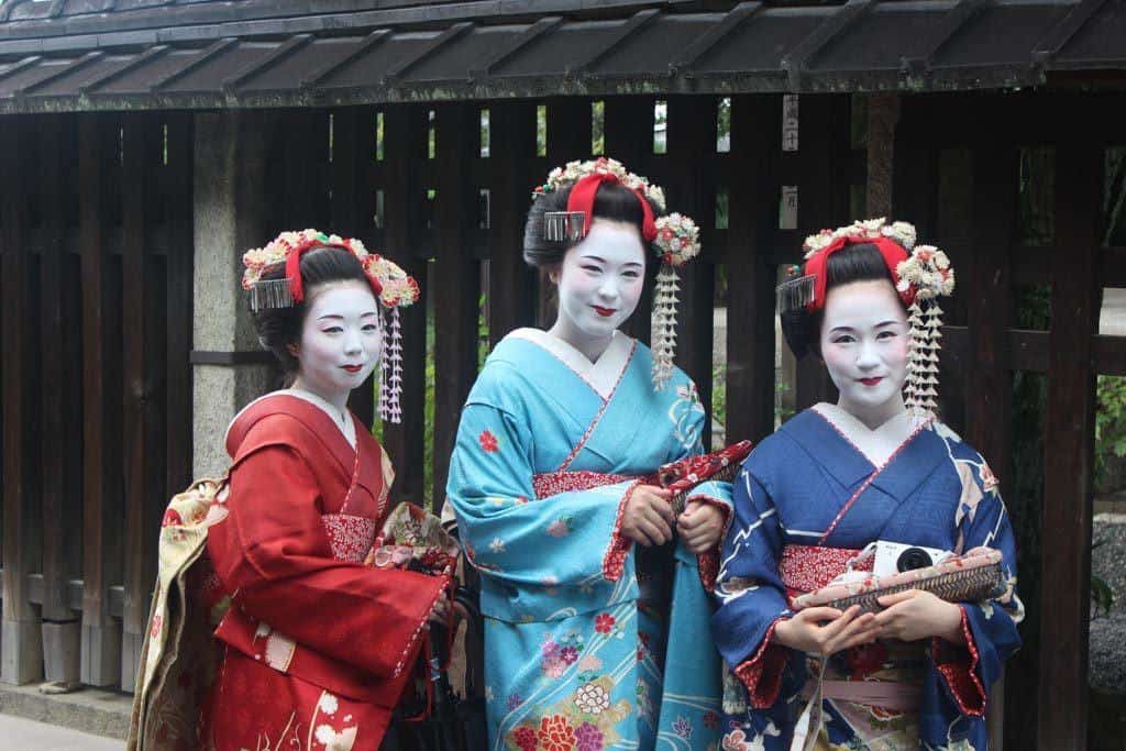 Three Geisha Standing Together In Japan